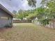 Large backyard with a privacy fence and mature trees surrounding the property at 876 Lobster Ct, Kissimmee, FL 34744