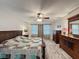 Bedroom with wood laminate flooring, ceiling fan, and matching dresser set at 876 Lobster Ct, Kissimmee, FL 34744
