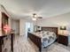 Large bedroom boasts wood laminate flooring, ceiling fan, and access to the en suite bathroom at 876 Lobster Ct, Kissimmee, FL 34744