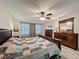 Spacious bedroom featuring wood laminate flooring, ceiling fan, and a coordinated furniture set at 876 Lobster Ct, Kissimmee, FL 34744