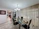 Dining room featuring modern decor, natural light, and seamless flow to the outdoor pool area at 876 Lobster Ct, Kissimmee, FL 34744