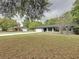 Charming single-story home featuring an attached garage, a well-maintained lawn, and freshly painted exterior at 876 Lobster Ct, Kissimmee, FL 34744