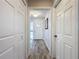 Hallway with white doors and wood floors leads to the front entrance at 876 Lobster Ct, Kissimmee, FL 34744