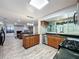 Modern kitchen featuring stainless steel appliances, granite countertops, and an open layout to the living room at 876 Lobster Ct, Kissimmee, FL 34744