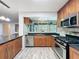 Updated kitchen with granite counters, stainless appliances, and ample storage at 876 Lobster Ct, Kissimmee, FL 34744