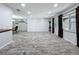Bright living room with wood-look flooring, recessed lighting and large windows at 876 Lobster Ct, Kissimmee, FL 34744