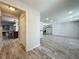 Open concept living room featuring modern flooring and access to the kitchen and dining areas at 876 Lobster Ct, Kissimmee, FL 34744