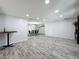 Spacious open-concept living room, showing dining area and wood-look floors at 876 Lobster Ct, Kissimmee, FL 34744