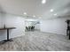 Large living room with wood-look floors, recessed lighting, and an open layout at 876 Lobster Ct, Kissimmee, FL 34744