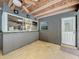 Covered patio with concrete flooring features access to the home's kitchen at 876 Lobster Ct, Kissimmee, FL 34744