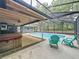 Screened-in pool with hot tub and outdoor seating provides the ultimate backyard retreat at 876 Lobster Ct, Kissimmee, FL 34744