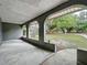 View of the covered porch with archways, showing outdoor space and a view of the front yard at 876 Lobster Ct, Kissimmee, FL 34744