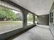 View of the covered porch with archways, showing outdoor space and a view of the front yard at 876 Lobster Ct, Kissimmee, FL 34744