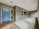 View of the covered porch and entryway with a blue door, showing outdoor space and curb appeal at 876 Lobster Ct, Kissimmee, FL 34744