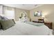 Cozy bedroom with a bed, desk, TV, and modern decor at 917 Orange Cosmos Blvd, Davenport, FL 33837