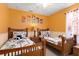 Bright bedroom with twin beds, neutral carpet and colorful animal themed artwork at 917 Orange Cosmos Blvd, Davenport, FL 33837