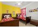 Colorful ' bedroom with twin beds, cartoon-themed décor and hardwood floors at 917 Orange Cosmos Blvd, Davenport, FL 33837