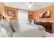 Comfortable bedroom with warm walls, a modern TV, and stylish accents at 917 Orange Cosmos Blvd, Davenport, FL 33837