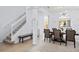 Bright dining area with modern chandelier, staircase and view into the kitchen at 917 Orange Cosmos Blvd, Davenport, FL 33837