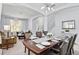 Formal dining table set with silverware and decor, with living area in background at 917 Orange Cosmos Blvd, Davenport, FL 33837