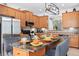 Beautiful kitchen with wooden cabinets, granite countertops, stainless steel appliances, and an island with seating at 917 Orange Cosmos Blvd, Davenport, FL 33837