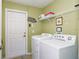 Bright laundry room featuring a washer, dryer, shelving, and decor at 917 Orange Cosmos Blvd, Davenport, FL 33837