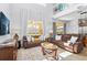 Bright living room featuring two sofas, a glass coffee table, and a large window with views of the backyard at 917 Orange Cosmos Blvd, Davenport, FL 33837