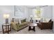 Cozy living room features plush seating, natural light, and stylish decor at 917 Orange Cosmos Blvd, Davenport, FL 33837