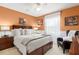 Spacious main bedroom featuring a cozy queen-sized bed, soft carpet, and light-filtering window at 917 Orange Cosmos Blvd, Davenport, FL 33837