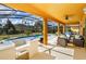 Covered patio featuring comfortable seating and a bar area perfect for outdoor entertaining at 917 Orange Cosmos Blvd, Davenport, FL 33837