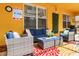 Covered patio with comfortable seating, a vibrant rug, and bright sunny view at 917 Orange Cosmos Blvd, Davenport, FL 33837