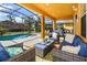 Covered patio featuring comfortable seating area perfect for outdoor relaxation at 917 Orange Cosmos Blvd, Davenport, FL 33837