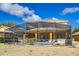 Back of the house featuring screened pool, outdoor seating, and backyard at 917 Orange Cosmos Blvd, Davenport, FL 33837