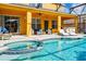 Enjoy the pool and patio with covered outdoor seating and lounge chairs for relaxing at 917 Orange Cosmos Blvd, Davenport, FL 33837