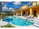 Screened-in pool and jacuzzi with a poolside lounge area, and sunny skies at 917 Orange Cosmos Blvd, Davenport, FL 33837