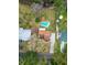 Aerial view featuring a swimming pool with a cabana, a house, a shed, and a long driveway to the street at 9916 Jackson Rd, Leesburg, FL 34788