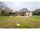 Expansive backyard featuring a pool, cabana, and plenty of green space at 9916 Jackson Rd, Leesburg, FL 34788