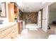 Bathroom features stone-accented tub and shower at 9916 Jackson Rd, Leesburg, FL 34788