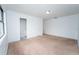 Spacious bedroom featuring neutral carpet, white walls, and natural light at 9916 Jackson Rd, Leesburg, FL 34788