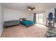 Spacious bedroom includes access to the backyard and a comfortable seating area at 9916 Jackson Rd, Leesburg, FL 34788