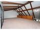 Bonus room featuring a vaulted ceiling with wood beams and a view of the stairway at 9916 Jackson Rd, Leesburg, FL 34788