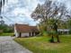 Spacious home featuring a long driveway, mature trees, and a lush green lawn at 9916 Jackson Rd, Leesburg, FL 34788