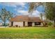 Charming single-story home with a well-maintained lawn and a cozy front porch at 9916 Jackson Rd, Leesburg, FL 34788