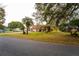Charming home with a spacious front yard and mature trees providing shade and curb appeal at 9916 Jackson Rd, Leesburg, FL 34788