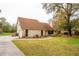 Charming home with a spacious lawn, mature trees, well-maintained landscaping, and a welcoming exterior at 9916 Jackson Rd, Leesburg, FL 34788