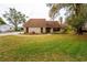 Charming home with a well-manicured lawn, mature trees, and inviting curb appeal on a sunny day at 9916 Jackson Rd, Leesburg, FL 34788