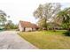 Charming home featuring mature trees, landscaping, a well-maintained lawn, and inviting curb appeal at 9916 Jackson Rd, Leesburg, FL 34788