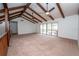 Spacious living room with vaulted ceilings, exposed beams, ceiling fans, and sliding glass doors at 9916 Jackson Rd, Leesburg, FL 34788