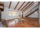 Bright living room showcasing wood floors and an open staircase at 9916 Jackson Rd, Leesburg, FL 34788