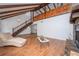 Bright living room showcasing wood floors, a stone fireplace, and an open staircase at 9916 Jackson Rd, Leesburg, FL 34788